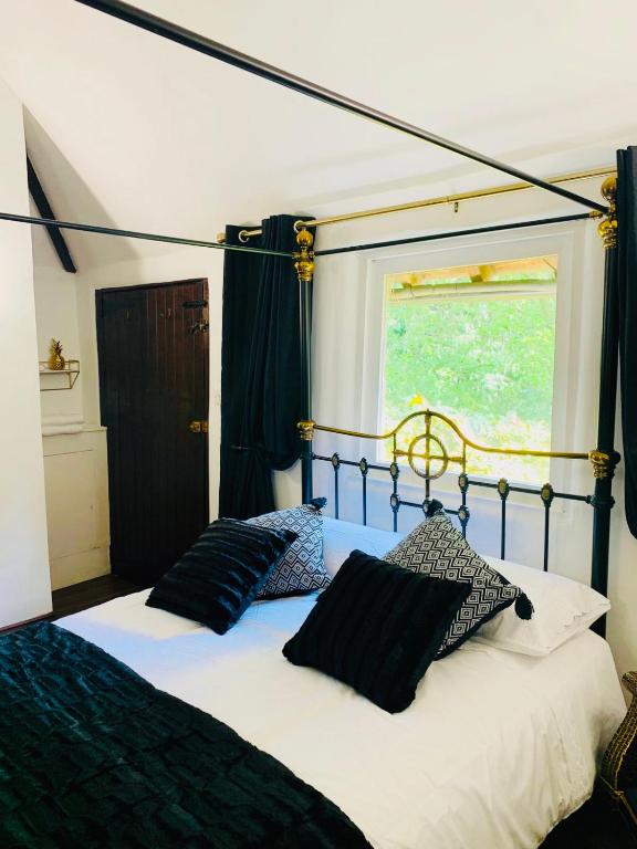 The Bogart — black and gold four-poster